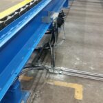 Blue equipment, piping, and controls along the wall