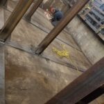 Welding activity and steel rack frames in a fabrication area. View 1 of 5