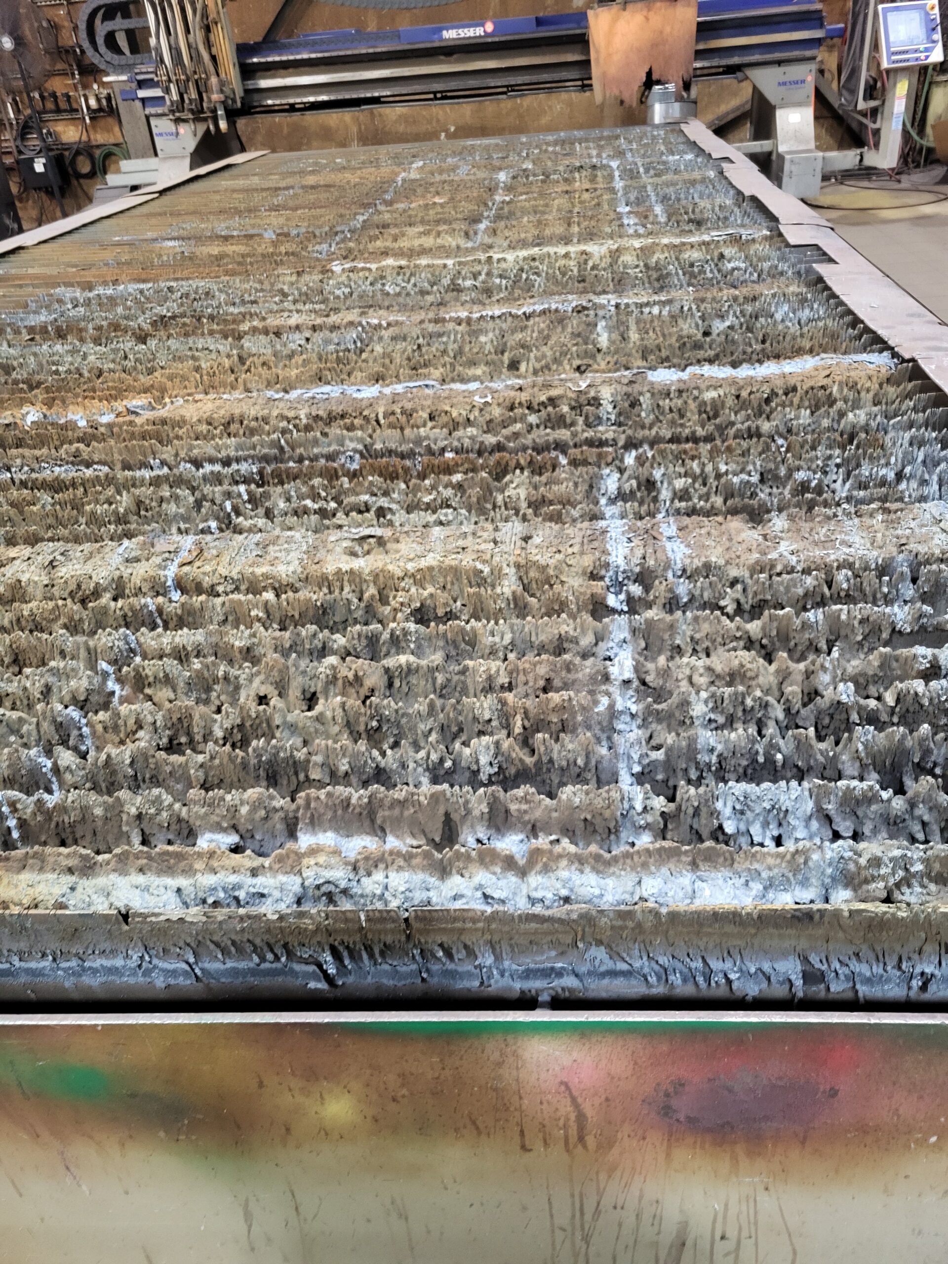 Plasma cutting table before scheduled cleanout and slat replacement.