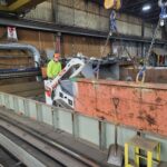 Extracted material being moved out of the plasma-table work area