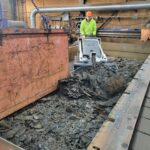 Breaking apart and removing dense accumulated debris from the table