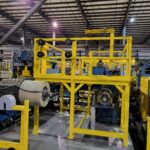 Large yellow fabricated framework around production equipment