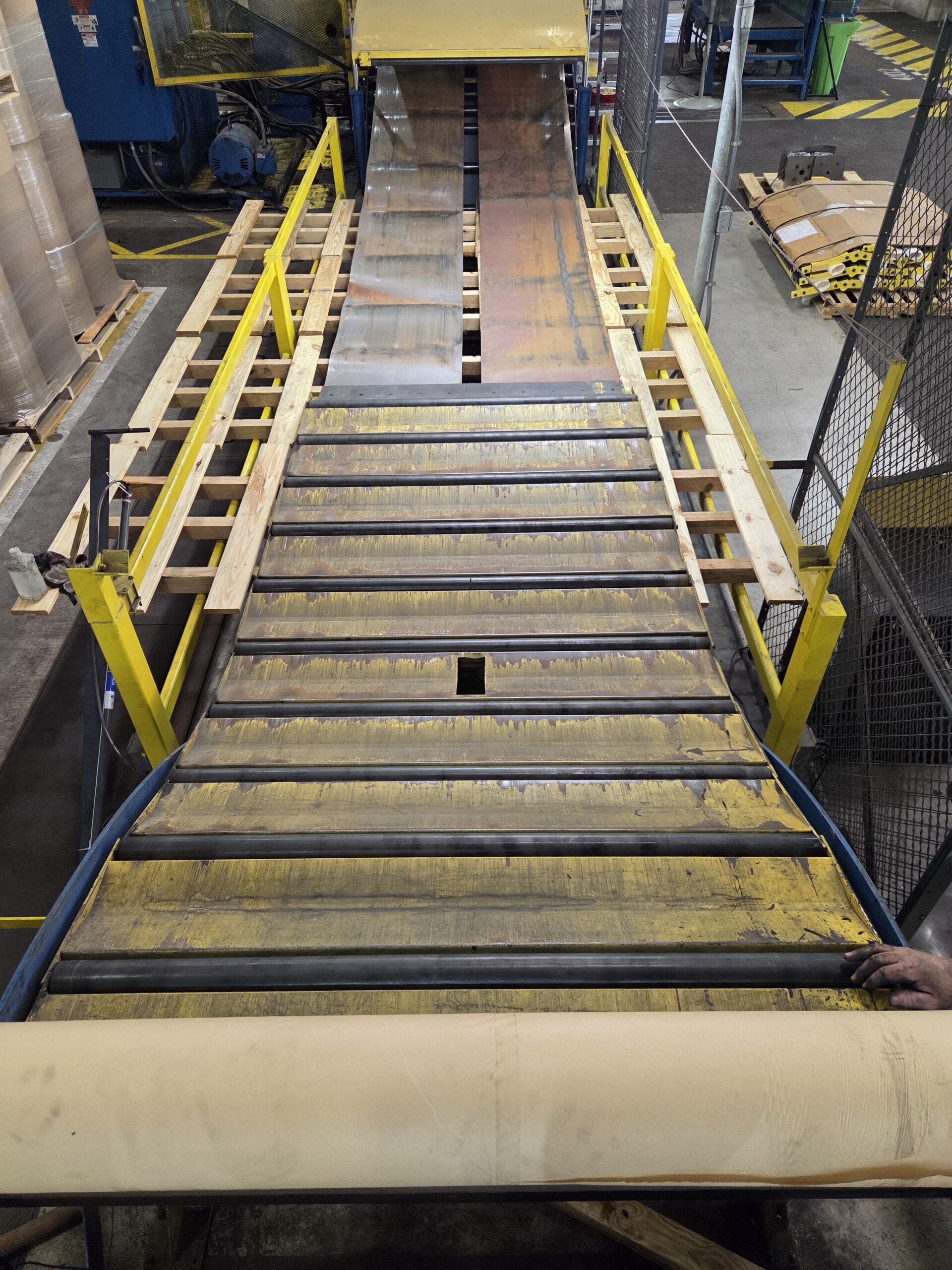 Industrial conveyor and roller section during repair work.