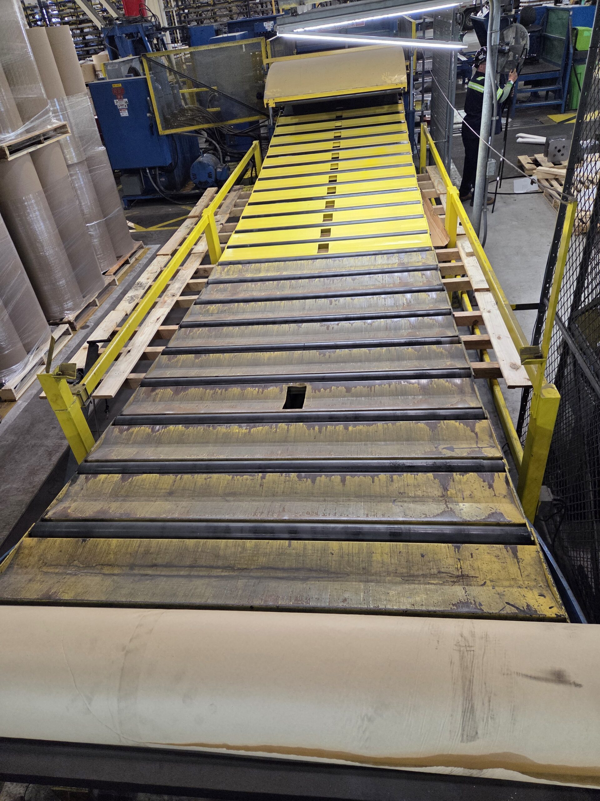 Industrial conveyor and roller section during repair work.