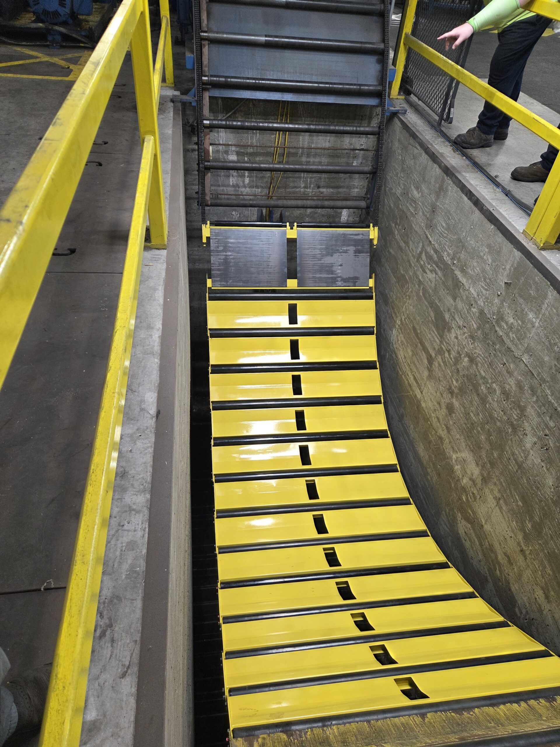 Industrial conveyor and roller section during repair work.