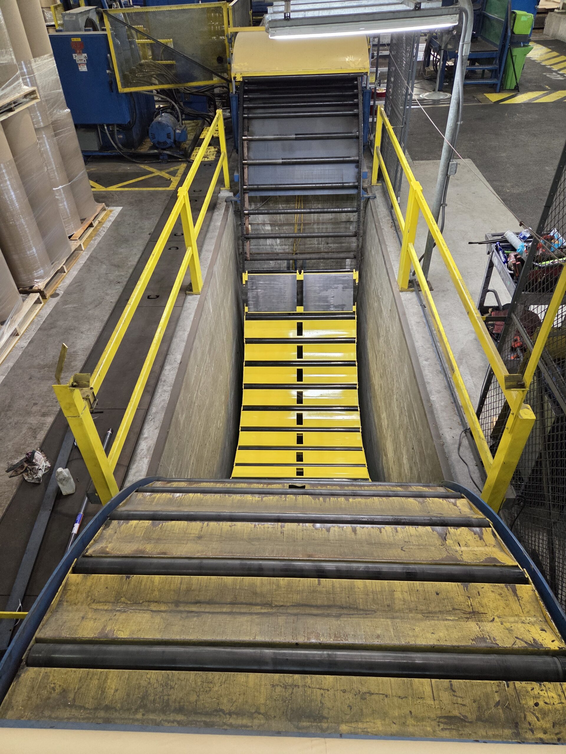 Industrial conveyor and roller section during repair work.