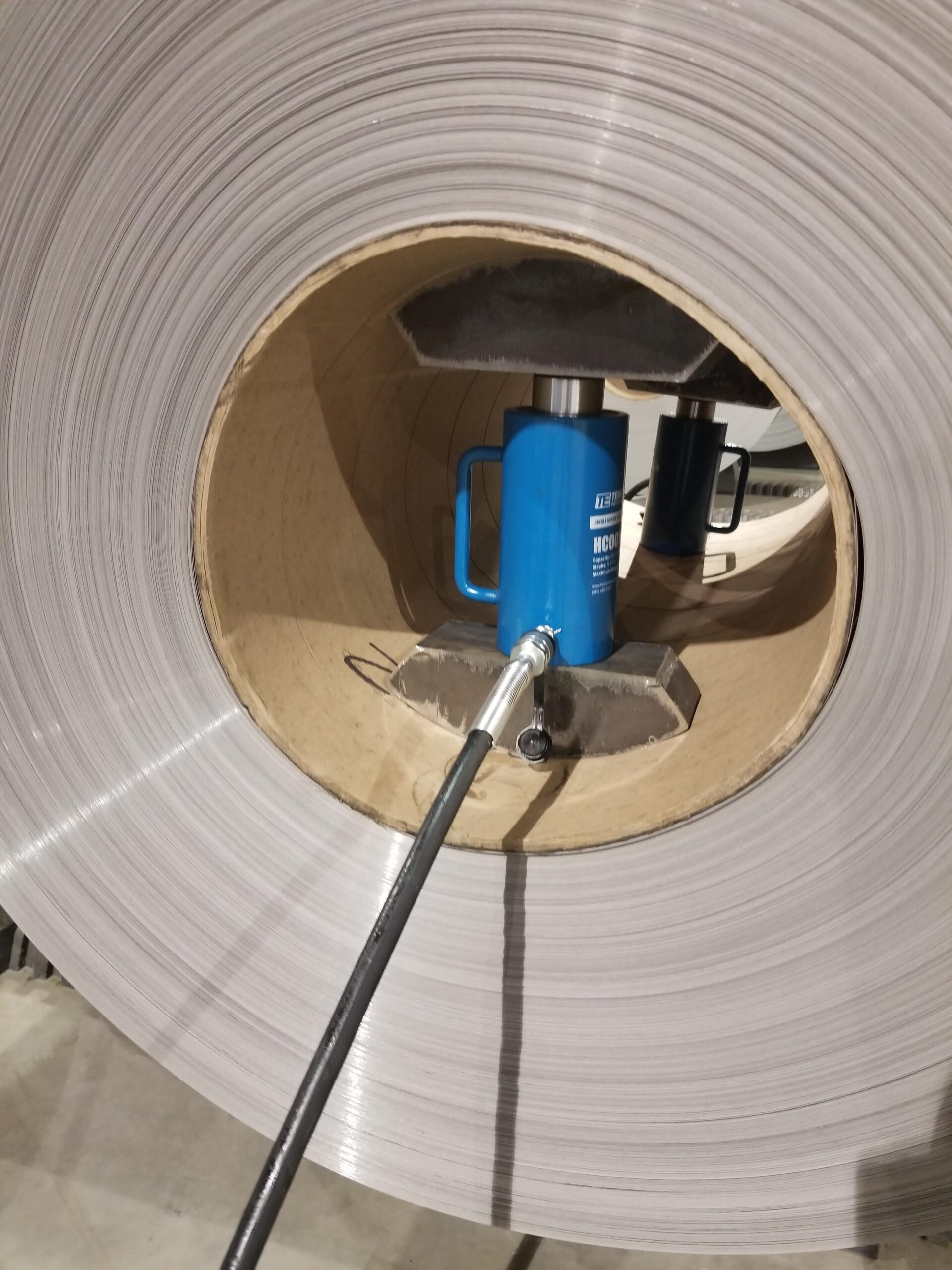 Hydraulic equipment reshaping a damaged coil eye.