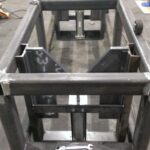 Welded workstation frame shown upright from several sides. View 3 of 3