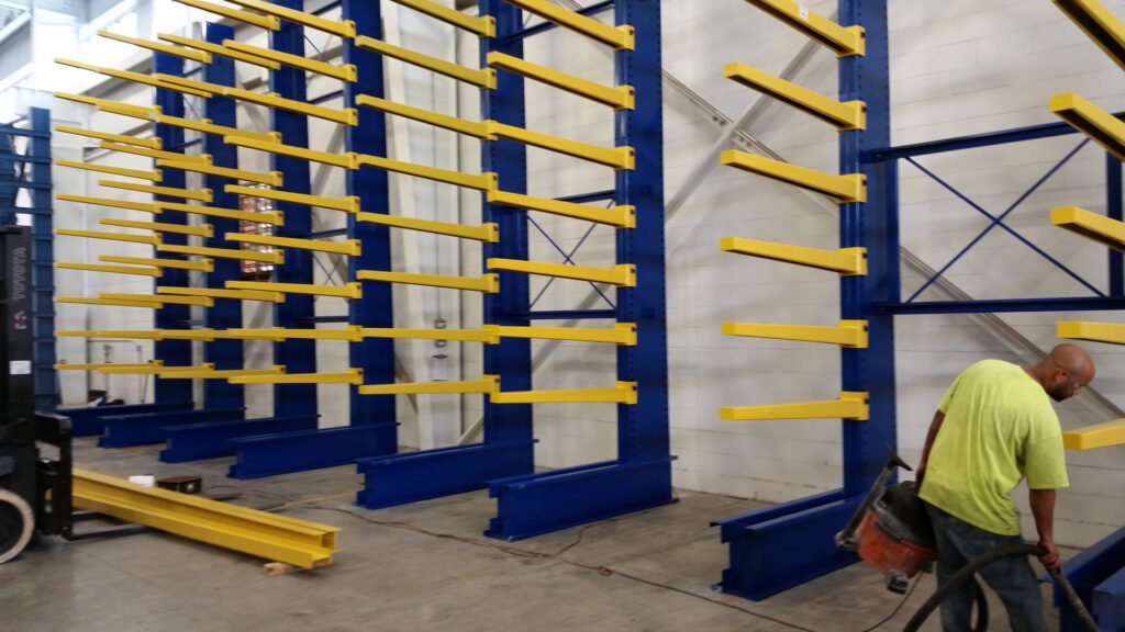 Cantilever-rack work area with a worker and rack components