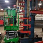 Lift positioned in an industrial rack aisle