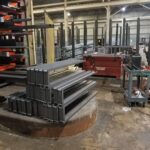 Steel industrial rack components staged in a work area