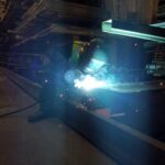 Active repair work at the lower section of industrial racking
