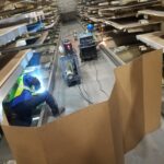 Screened work area at an elevated section of industrial racking