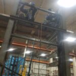 Work at an upper section of industrial rack structure