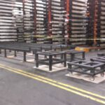 Industrial staging and skid table frames in a work area