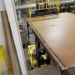 Overhead view of fabric cutter table sections being moved into the new production area