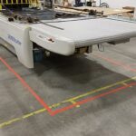 Fabric-cutting equipment positioned in the marked main-floor production area
